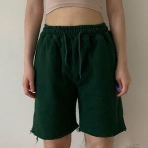 Green jersey shorts with raw hem